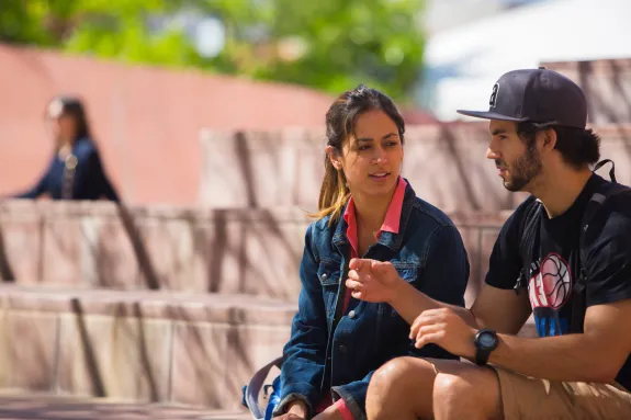 Image of two students having a conversation